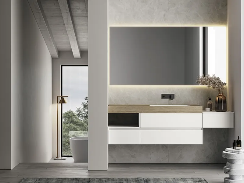Eleganza e dinamicità per la composizione Nyù che vede la presenza del piano in HPL Yacht (alto 12 cm) con lavabo integrato in Mineralsolid Bianco opaco.